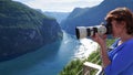 Tourist taking photo of fjord landscape, Norway Royalty Free Stock Photo