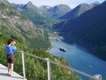 Tourist taking photo of fjord landscape, Norway Royalty Free Stock Photo