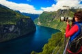 Tourist taking photo of fjord landscape, Norway Royalty Free Stock Photo