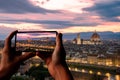 Tourist taking photo of Florence at sunset from Piazzale Michelangelo, Florence, Italy. Beautiful panoramic view of Duomo Santa Royalty Free Stock Photo