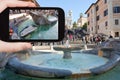 Tourist taking photo fountain on Spanish square