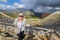 Tourist taking photo in front of greek theater of Segesta, Sicily, Italy Royalty Free Stock Photo