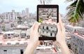 Tourist taking photo of houses in old Havana city Royalty Free Stock Photo