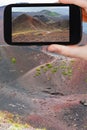 Tourist taking photo of path on slope of craters Royalty Free Stock Photo