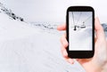Tourist taking photo of skiing tracks and ski lift Royalty Free Stock Photo