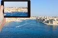 Tourist taking photo of skyline of Valletta