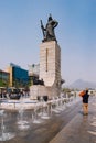 Tourist taking photo of the statue of the admiral Yi Sun-Sin in downtown Seoul, South Korea.
