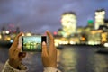 Tourist taking photo, Tower Bridge, London, with mobile phone