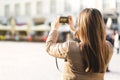 Tourist taking photo of town square during vacation with camera. Royalty Free Stock Photo