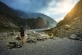 Tourist taking a photograph at fox glacier trekking trail most p Royalty Free Stock Photo