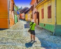 Tourist taking photos in Sighisoara medieval city.