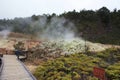 Tourist taking photos of a steam vent at Sulphur Banks in Volcanoes National Park, Hawaii