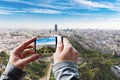 Tourist taking a picture of Aerial panoramic view of Paris.