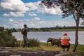 Tourist taking picture of Elephant walking next to the small lake, in Imire National Park, Zimbabwe Africa