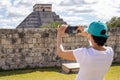 Tourist taking a picture and enjoying the mayan pyramid temple of Kukulkan in chichen itza Royalty Free Stock Photo