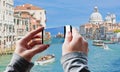 Tourist taking a picture of Grand Canal and Basilica Santa Maria