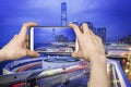 Taking picture of Hong Kong cityscape with smartphone Royalty Free Stock Photo