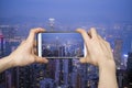 Taking picture of Hong Kong Skylines Cityscape with smartphone Royalty Free Stock Photo
