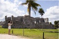 Tourist taking a picture of the mayan ruin of Tulum in summer, it is a relaxing paradise city by the sea belonging to the mayan Royalty Free Stock Photo