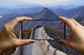 Tourist taking a picture with a mobile phone at the great wall in China Royalty Free Stock Photo