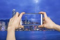 Taking picture of Hong Kong cityscape with smartphone Royalty Free Stock Photo