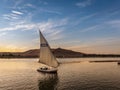 Tourist taking a ride in a Felucca boat in Luxor Egypt on the NIle River Royalty Free Stock Photo