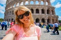 Tourist taking selfy photo in front of Colosseum in Rome Royalty Free Stock Photo