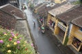 Tourist taking a tour to discover Hoi An ancient town by cyclo on a rainy day