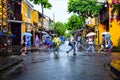 Tourist taking a tour to discover Hoi An ancient town walk on a rainy day