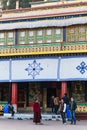 Tourist talk with Tibetan monk in front of Rumtek Monastery in winter near Gangtok. Sikkim, India