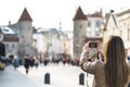 Tourist in Tallinn taking photo of Viru Gate. Royalty Free Stock Photo