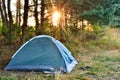 Tourist tent, against the backdrop of dawn in the woods