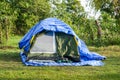 Tourist tent in forest camp among meadow Royalty Free Stock Photo