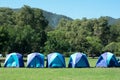 Tourist tent in forest camp among meadow. Royalty Free Stock Photo