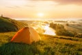 Tourist tent on meadow at sunrise Royalty Free Stock Photo