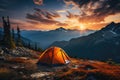 Tourist tent in the mountains under dramatic evening sky. Colorfull sunset in mountains. Traveler people enjoying the advanture