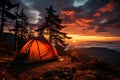 Tourist tent in the mountains under dramatic evening sky. Colorfull sunset in mountains. Traveler people enjoying the advanture