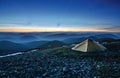 Tourist tent in the rocky mountains and first star Royalty Free Stock Photo