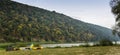 A tourist tent and three catamarans under Ukrainian flag on Dnister riverside, National Nature Park Dnister Canyon, Ukraine