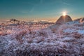 Tourist tent on top of the mountain. A pitched tent under blue morning sky. Sunlight over tourist tent, cold winter Royalty Free Stock Photo