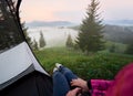 Tourist tent with woman legs in jeans and running shoes Royalty Free Stock Photo