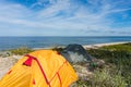 Tourist tents on the Baltic sea coast, camping on the sea coastline