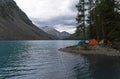 Tourist tents on the shore of a mountain lake. Altai, Russia.