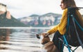 Tourist think traveler relax together dog on mountain scape, woman hug pet rest on lake shore nature trip