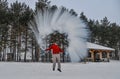 A tourist throwing hot water at winter park