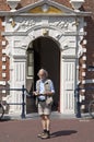 Tourist to read travel guide for old town hall Hoorn