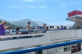 Tourist on top deck of lake ferry surround by Italian mountains Royalty Free Stock Photo