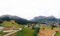 Tourist town Cortina d`Ampezzo, panoramic view with alpine green landscape and massive Dolomites Alps. View of houses and hotels, Royalty Free Stock Photo