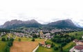 Tourist town Cortina d`Ampezzo, panoramic view with alpine green landscape and massive Dolomites Alps. View of houses and hotels, Royalty Free Stock Photo
