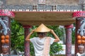 Tourist with traditional asian hat visiting Batak traditional village and Old Tomb of King Sidabutar in Tomok lake Toba, famous Royalty Free Stock Photo